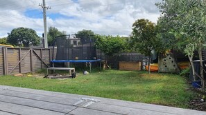 Enjoy a fun-filled stay with a backyard featuring a trampoline and play structure.