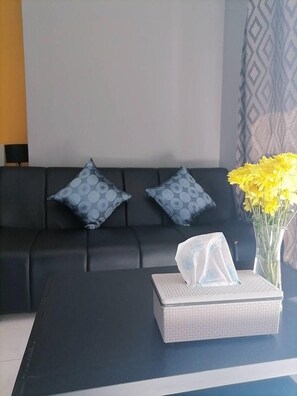 Relax in this stylish living room with a sofa, coffee table, and beautiful flowers.