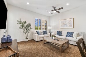 A living room with a sofa, coffee table, and a ceiling fan. - Mountain View! Cozy Luxury Retreat, Pet Friendly! - Upper (L76) (La Quinta)