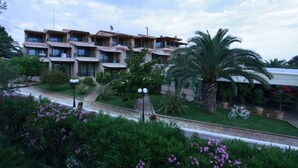 A multi-story hotel with balconies, surrounded by lush greenery and palm trees. - Ocean View (Pangaio)