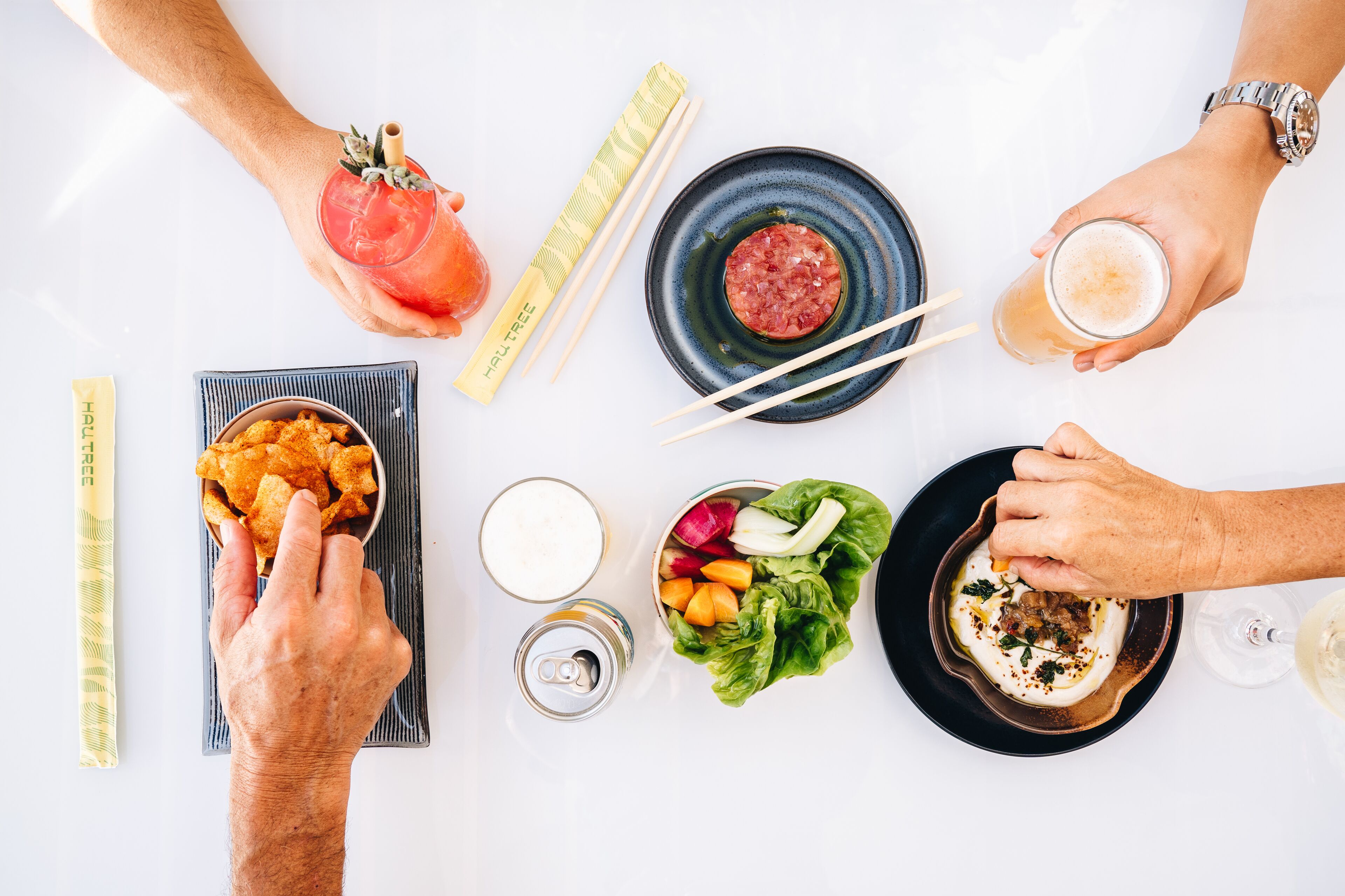 A table with various dishes, drinks, and utensils.