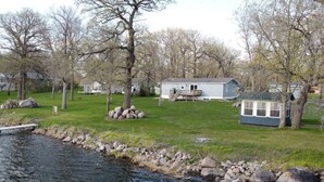 A lakeside property with a house, a dock, and a small cabin. - Enjoy Lake Life, A Great Minnesota Getaway! (Henning)