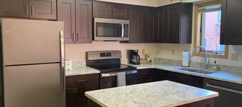Roomy 2-story home with furnished deck, grill, fireplace, & great location
