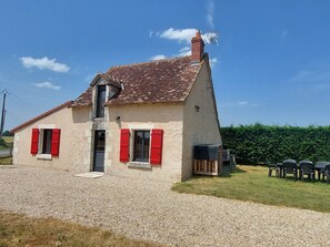 A two-story house with red shutters, a chimney, and a gravel driveway. - Charming Berry Home near Zoo de Beauval & Medieval Loches, Private Parking, Shared Garden (Arpheuilles)