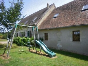 Enjoy a family-friendly home with a backyard slide and a grassy lawn.