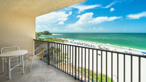 A balcony with a view of a beach and ocean. - Sandy Shores 504 1 BR Gulf Front (Madeira Beach)