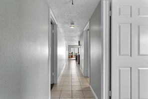 Clean lines and minimalist design define this corridor, leading to a simple door at the end.