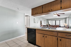 Enjoy cooking in this well-equipped kitchen with a large island, dishwasher, and sink.