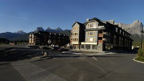A hotel with a traditional architectural style, featuring multiple stories and large windows. - Bear Creek Crossing - Your Cabin In A Condo! (Alberta)