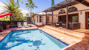 A swimming pool with a turtle design, outdoor seating, and palm trees. - House of Paddles, POOL, Ocean close in Keaau, Hawaii, near Hilo (Keaau)