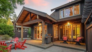 A two-story house with a covered patio area, outdoor seating, and a grill. - 1PM Check In/Out | A Suncadia Escape Where Nothing Feels Rushed! (Cle Elum)