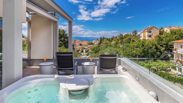 A rooftop terrace with a hot tub, two chairs, and a small table with a drink. - Villa with pool in the center of Malinska (Malinska)