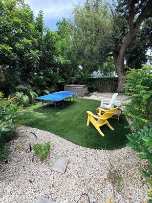 A backyard with a ping pong table, a hot tub, and outdoor seating. - WATER SLIDE & POOL ** SUGAR SHACK** (Bradenton)