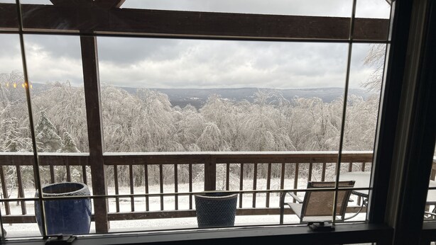 A balcony with wicker furniture and a view of a snowy landscape. - Private mountainside chalet bordering Dolly Sods with beautiful panoramic view. (Davis)
