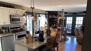 A kitchen with granite countertops, stainless steel appliances, and a central island with bar stools. - Private mountainside chalet bordering Dolly Sods with beautiful panoramic view. (Davis)
