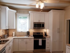 Fridge, microwave, oven, stovetop - The Beach Cottage at Michigan Blvd. (Racine)