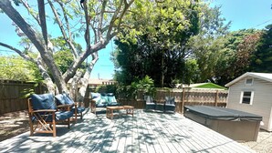 A wooden deck with outdoor furniture, a hot tub, and a shed. - WATER SLIDE & POOL ** Sugarcane Hideaway** (Bradenton)
