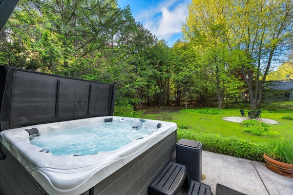 Unwind in the inviting hot tub, perfect for soothing your muscles after a day of adventure.