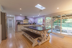 Enjoy cooking in this well-equipped kitchen with a central island, stainless steel appliances, and a window offering a view of the outdoors.