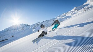 A snowy ski slope with two skiers. - Spacious chalet La Tania, with half-board (la perriere)