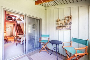 Enjoy meals in the dining area with a table and chairs, and a unique wooden sign on the wall.