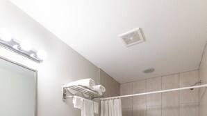 A modern bathroom with a sink, toilet, and bathtub. - Studio, 1 King Bed, Kitchenette - Non-Smoking (Baton Rouge)
