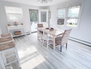 Enjoy meals in this spacious dining area with a wooden table and comfortable chairs.