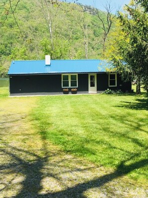 Situated in a serene grassy area, this single-story building offers a peaceful retreat.