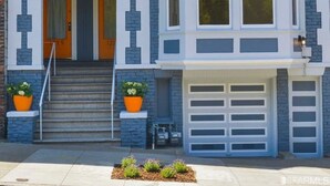 A two-story house with a bay window, a garage, and a front door. - Private Stylish Apartment in Cole Valley (San Francisco)
