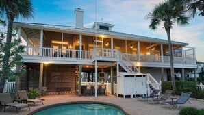 A two-story house with a pool, outdoor seating, and a covered patio. - Endless Summer - Home in Prestigious Community with Gulf Views & Secluded Pool Area (Miramar Beach)