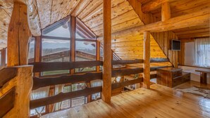 A wooden cabin with a high ceiling, large windows, and a cozy interior. - Amazing home in Sveti Rok (Sveti Rok)