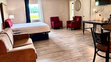 Suite, 1 King Bed with Sofa bed, Non Smoking | Desk, laptop workspace, blackout curtains, iron/ironing board