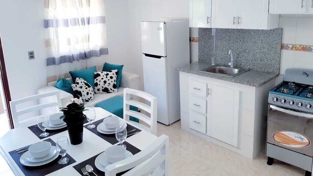 Economy Apartment | Private kitchen | Full-sized fridge, microwave, cookware/dishes/utensils, dining tables - Residencial Estrellitas (Punta Cana)