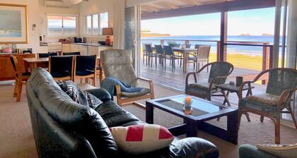 House at the beach, the sounds of waves on the breeze
