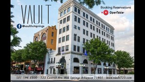 A multi-story building with a classic architectural style, featuring arched windows and a central entrance. - In the Heart of Downtown Historic Hot Springs (Hot Springs)