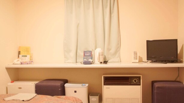 A hotel room with a bed, a desk with a computer, a telephone, and a window with curtains. - Business Hotel Chateau Est Takamatsu (Takamatsu)