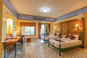 A hotel room with two beds, a desk, and a chair. - Pung Waan Resort Spa (Kanchanaburi)