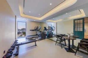 A modern gym with cardio machines, weight stations, and a view of the city. - Jinjiang Inn (Tianjin South Railway Station) (Tianjin)