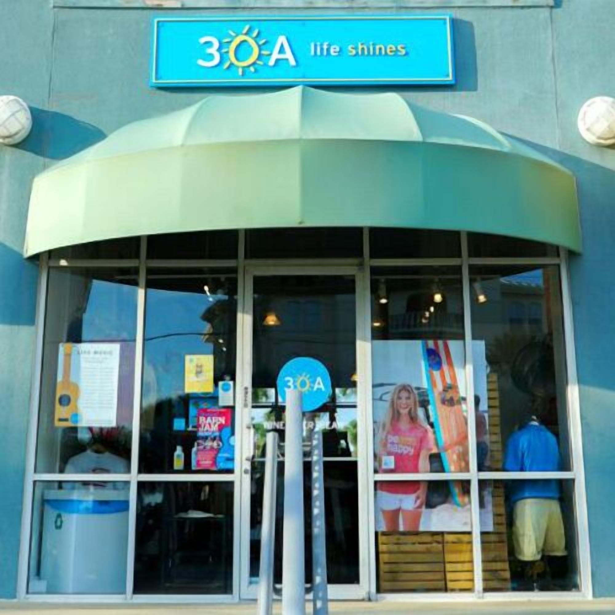 A storefront with a sign reading "3OA life shines" and a large glass window displaying various items.