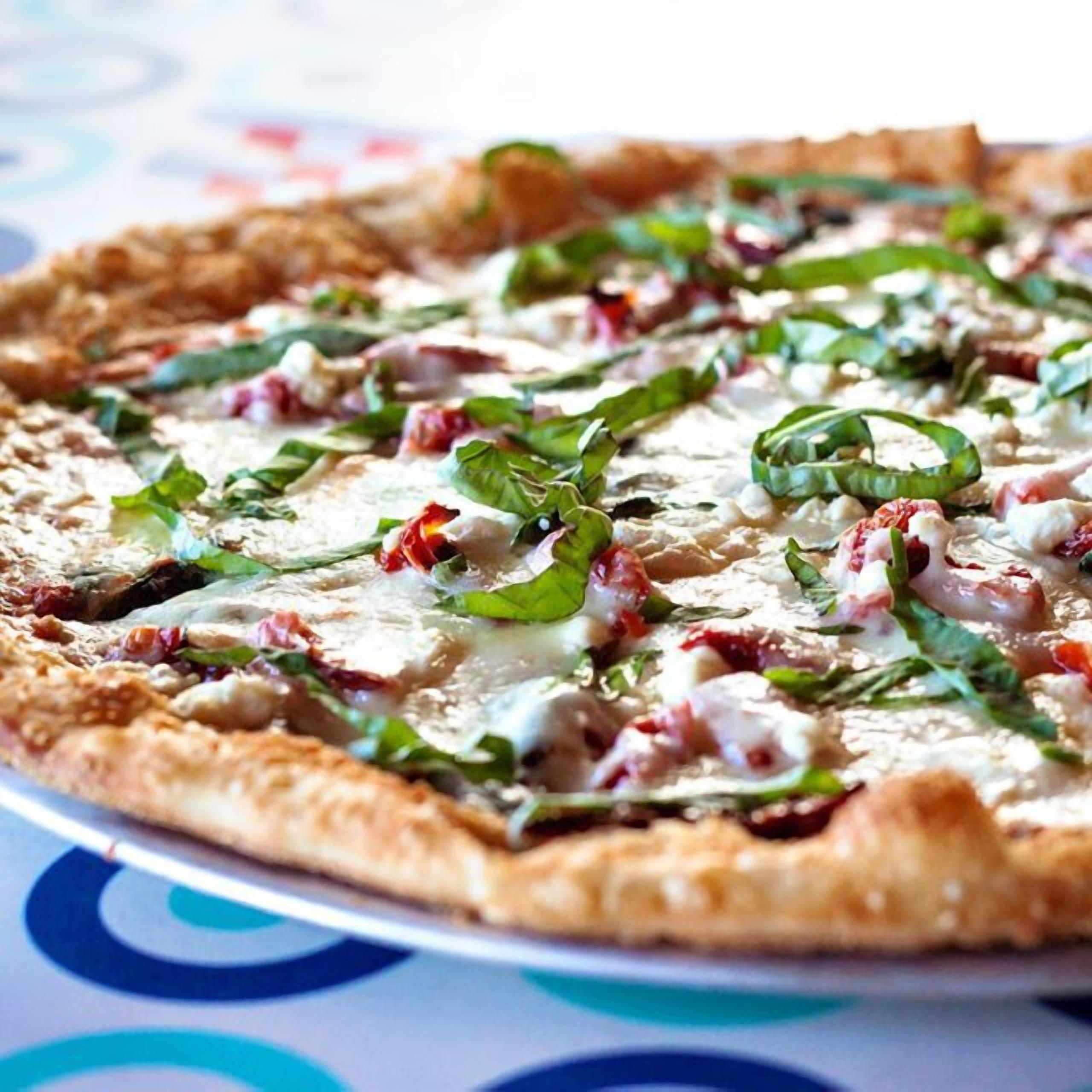 A pizza with various toppings on a plate.
