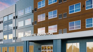 A modern hotel with a two-story facade, large windows, and a prominent entrance. - AC by Marriott Portland Beaverton (Beaverton)