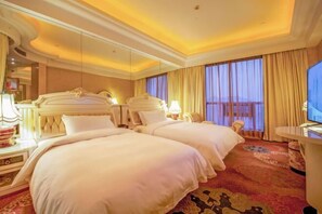 A hotel room with two beds, a large mirror, a television, and a desk with a chair. - Platinum Hanjue Hotel (Cixi)