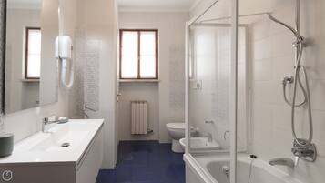 A modern bathroom with a shower, toilet, and sink.