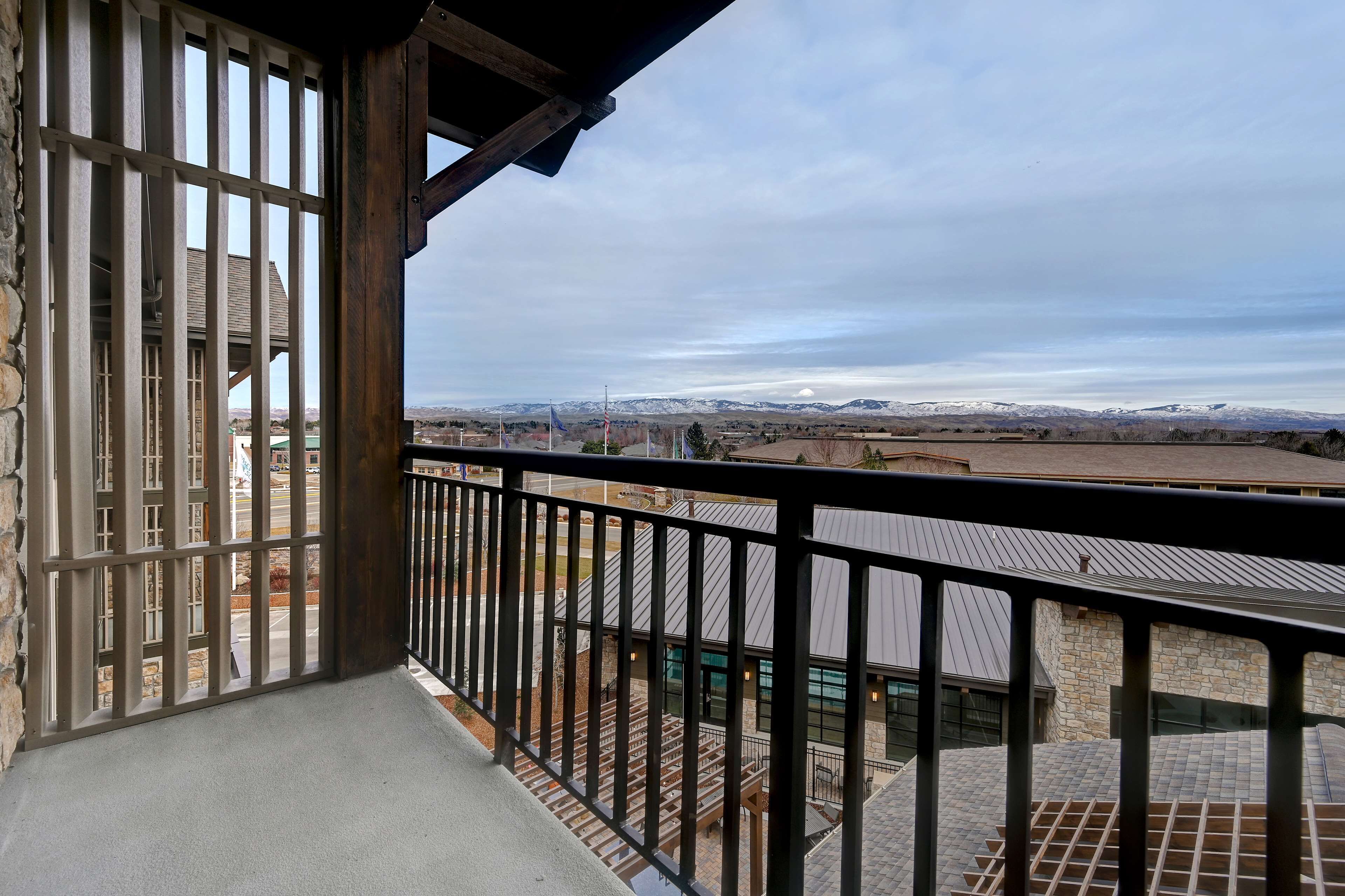 A balcony with a view of a mountainous landscape.
