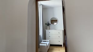 A narrow hallway with a white dresser, a mirror, and a small bench. - Coastal 2-bed Cottage for 4 Cellardyke, Anstruther (Anstruther)