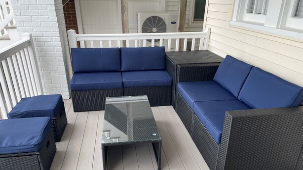 A covered outdoor seating area with wicker furniture and blue cushions. - Peace and quiet within short walking distance to the beach.  (Ocean City)