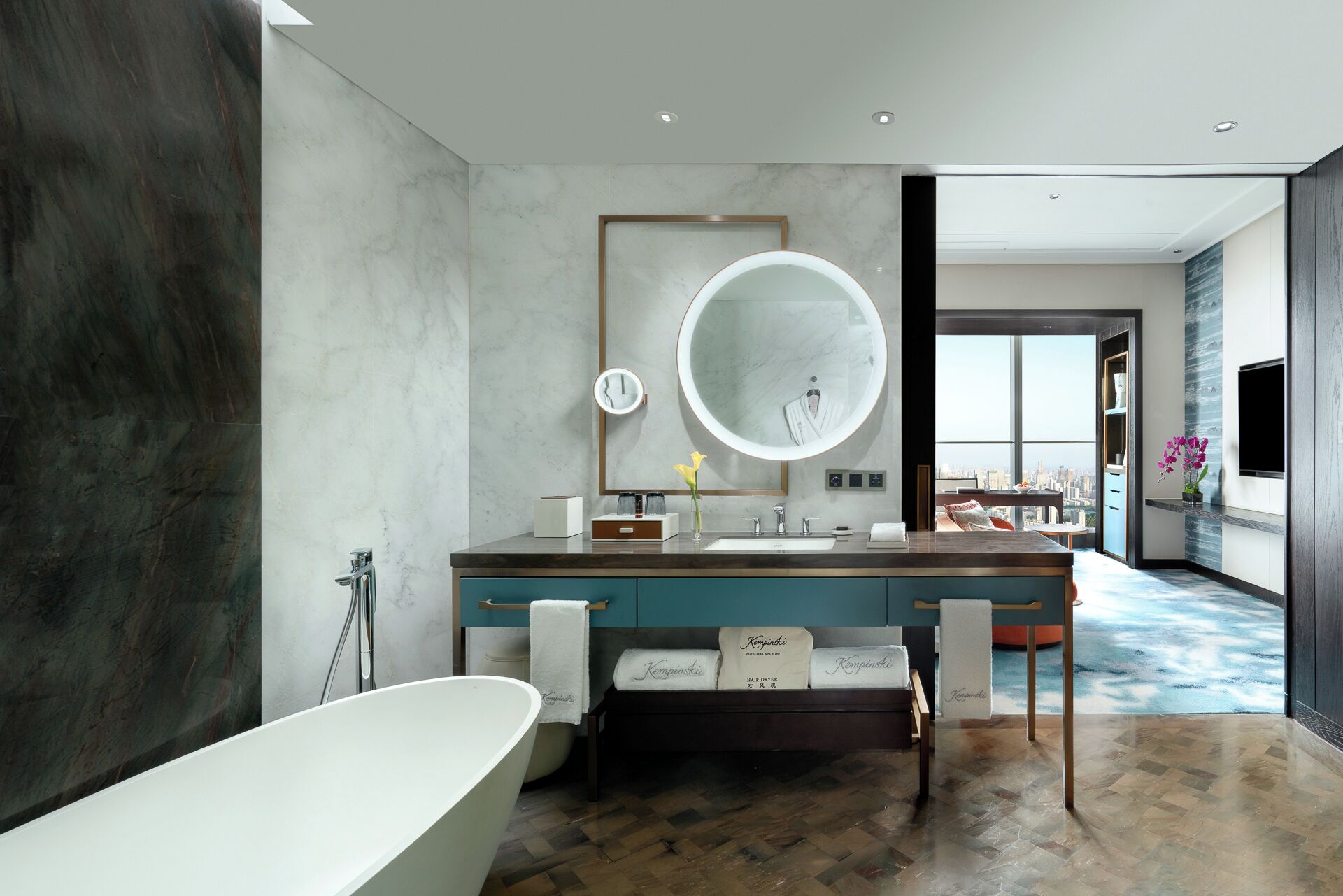 A modern bathroom with a freestanding bathtub, a large mirror, and a vanity with a sink.