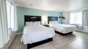 A hotel room with two beds, a nightstand, a lamp, and a window with curtains. - Everglades City Motel - Queen Room, 2 Beds, Kitchenette (Everglades City)
