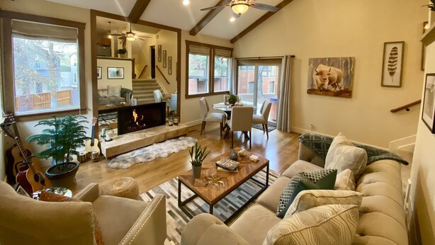 A spacious living room with a fireplace, comfortable seating, and a dining area. - Prime Skier's Pad for a Magical Vacation (Cottonwood Heights)
