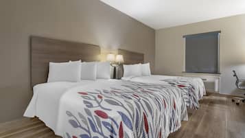 A hotel room with a large bed, a nightstand with a lamp, a window, and a view of the outside.
